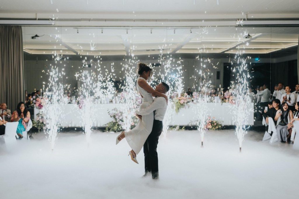 Beauitful couple married in the Ballroom at Leonda by the Yarra with indoor fireworks in the background during their first dance